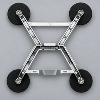 Underside of the aluminum X-frame bracket showing four rubber-wrapped magnetic feet
