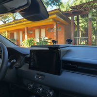 Low-profile Starlink Mini platform supported on a vehicle dashboard